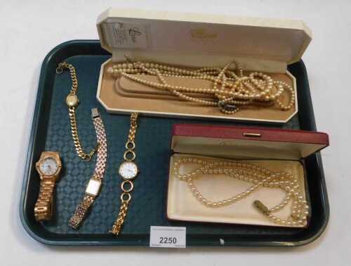 Faux pearl necklaces, both boxed, and a quantity of gold plated wristwatches. (1 tray)