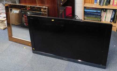 A square mirror and a 40" flat-screen television, model number KDL-40EX403, with remote.