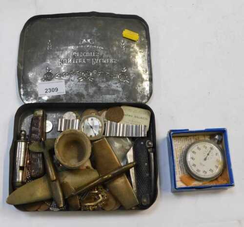 A tin containing British currency, two brass aeroplanes, a flat penknife, another flat penknife,...