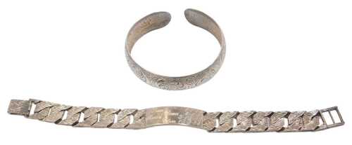 A silver textured curb-link identity bracelet, on a snap clasp, 1.83oz, together with a cuff...