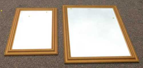 A large gilt framed bevelled mirror, 91cm x 118cm, and one smaller bevelled mirror, with gilt...
