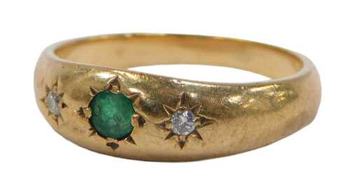 A 9ct gold dress ring, with a central emerald, flanked by two diamonds, on a plain shank, size K,...