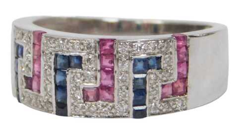 A white metal dressing ring, cut with red, white and blue stones, in a key design, size N 1/2.