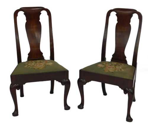 A pair of George II mahogany side chairs, with carved and shaped splat backs, drop-in seats,...