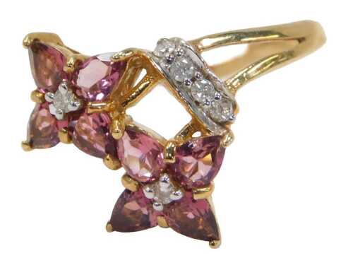 A 9ct gold dress ring, set with white stones and topaz, in two floral clusters, stamped GTV,...