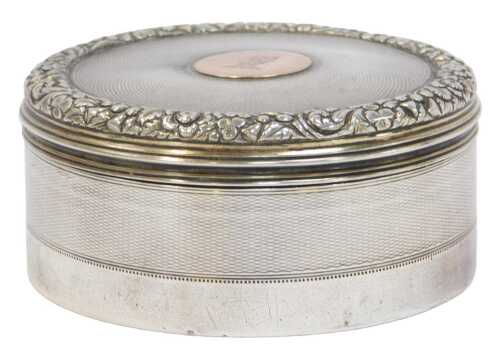 A George IV silver cylindrical box and cover, with engine-turned decoration, the lid with a...