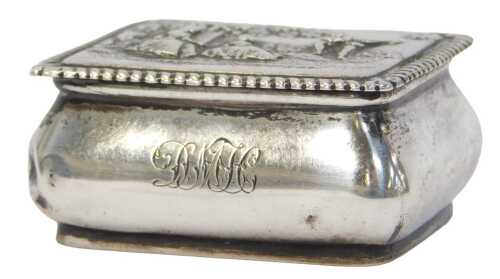 A Victorian small silver snuff box, the hinged lid cast with figures, the base with shaped sides...