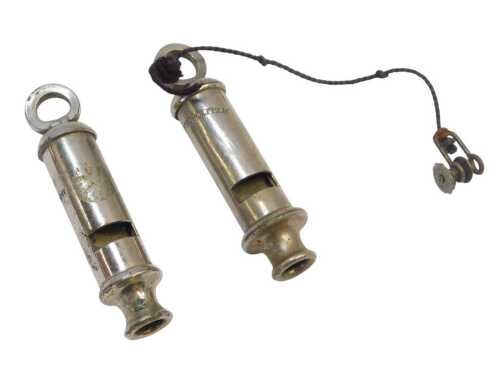 Two chrome police whistles, one stamped The Metropolitan. (2)