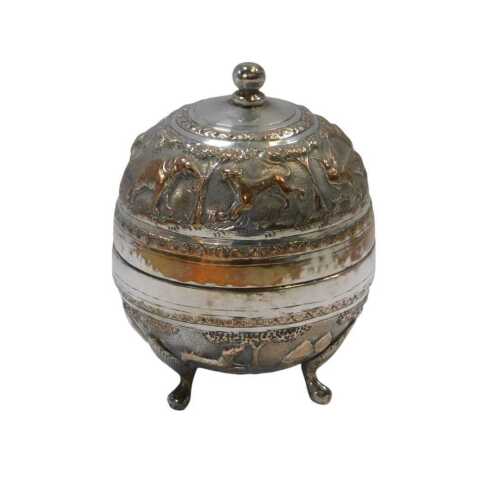 An early 20thC Anglo-Indian silver-plated canister, embossed with wild animals, flowers and...