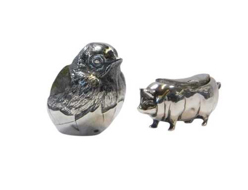 An Edward VII silver pin cushion, modelled as a chick in an egg, with a green velvet cushion,...