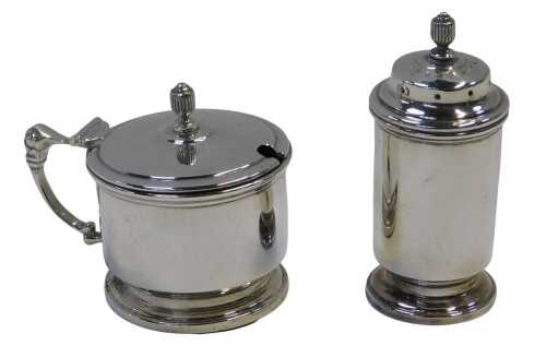 A George VI silver lidded mustard pot and pepper pot, each of cylindrical form with raised...