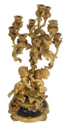 A 19thC French gilt metal five-branch candelabrum, of scrolling form with putti supports, the...