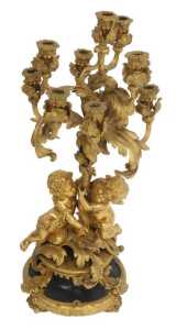 A 19thC French gilt metal five-branch candelabrum, of scrolling form with putti supports, the...