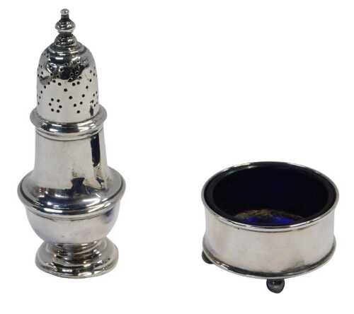 A George V silver open salt, of plain form, raised on four ball feet, with a blue glass liner,...