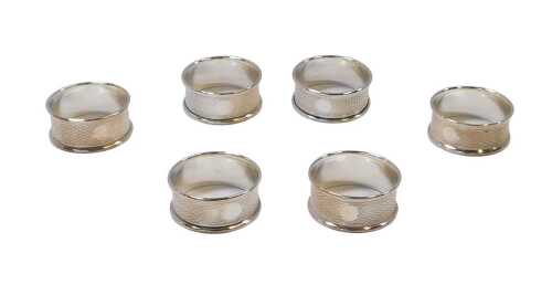 A set of six George V silver engine-turned napkin rings, Birmingham 1926, 1.41oz, in a fitted box.