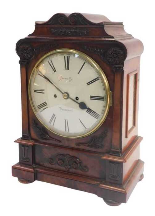 An early Victorian mahogany bracket clock, with a carved scroll-top breakfront case with bun...