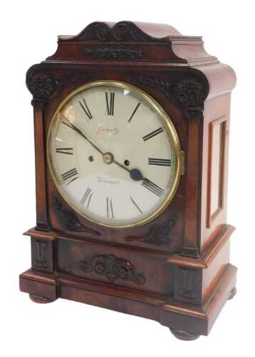 An early Victorian mahogany bracket clock, with a carved scroll-top breakfront case with bun...