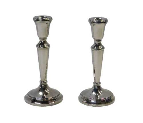 A pair of Elizabeth II filled silver candlesticks, each of slender cylindrical tapering form,...