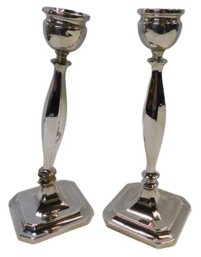 A pair of Edward VIII filled silver candlesticks, of slender form, each raised on a stepped...