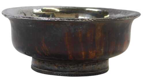 A Tibetan white metal and burr wood tea bowl, with a hammered white metal interior and banded...