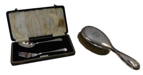 A George V silver Christening set, comprising fork and spoon, initialled LCM, 1.52oz, boxed,...