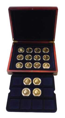 Sixteen Queen Elizabeth II gold-plated commemorative one-crown coins, contained in a fitted box.