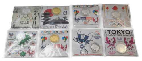 Eight Tokyo 2021 Olympics commemorative coins, six silver coloured and two gold coloured, each...
