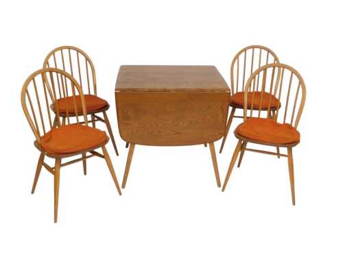 An Ercol light elm kitchen table, with drop leaves, 140cm x 75cm when opened, and a set of four...