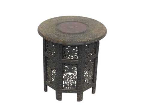 An Indian hardwood occasional table, with a circular top carved with elephants and a foliate...