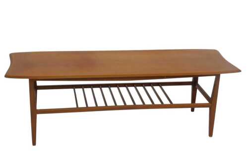 A Vintage mid-century teak coffee table, with a chamfered moulded top and a spindled undershelf,...