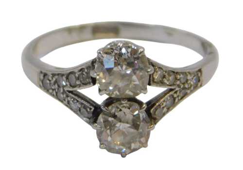 An Art Deco diamond ring, set with two old round-cut stones of 5.2mm diameter each, split shoulders set with seven tiny stones of 1mm, shank stamped PLAT., size N-O, 4g all in, in a Garrard & Co articulated box.