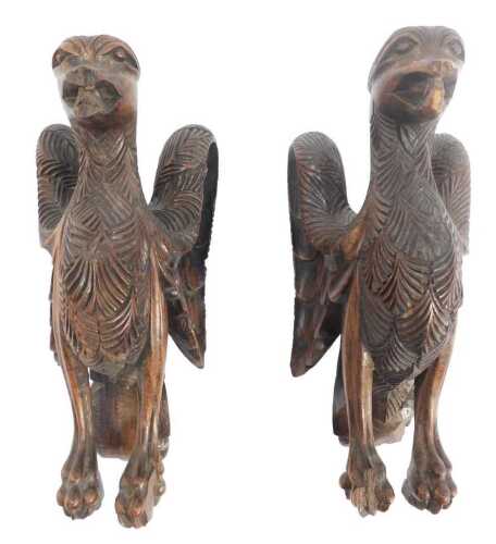 A pair of 19thC carved hardwood eagles, possibly mounts to a piece of furniture, 23cm high.
