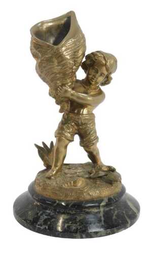 A late 19thC gilt metal figural match strike, modelled as a boy wearing upturned shorts and a...