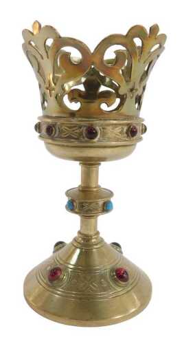 An Arts and Crafts brass chalice or candle holder, the pierced scrolling top above a band of...