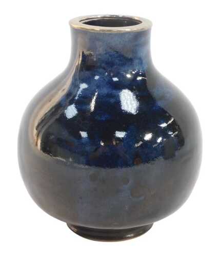 A 20thC studio pottery vase, of globular form with an elongated neck, the rim with a white metal...