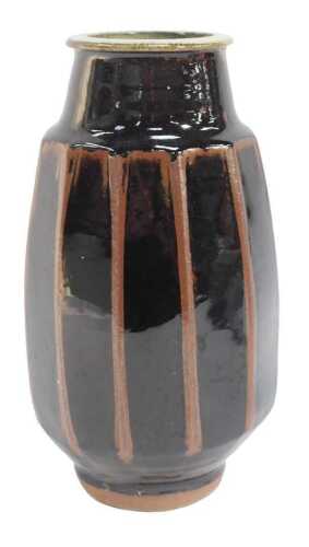 A George Rainer studio pottery stoneware vase, of cylindrical faceted form, in a two-tone brown...