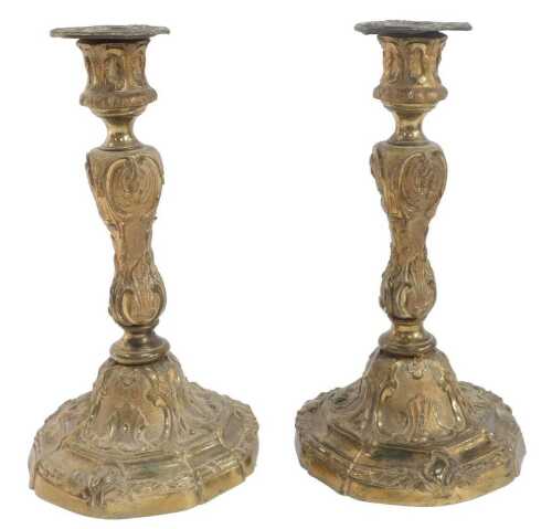 A pair of Louis XV-style gilt-brass candlesticks, decorated with leaves and scrolling motifs,...