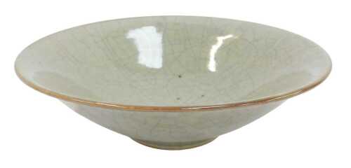 A 20thC studio pottery celadon glazed bowl, 28cm diameter.