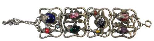 A contemporary four-link bracelet, white metal and coloured art glass, cast as open panels of...