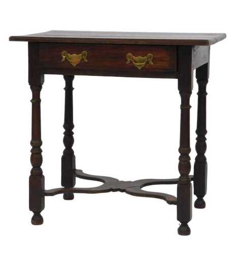 An oak side table, the planked top above a frieze drawer with brass drop handles, on turned legs...