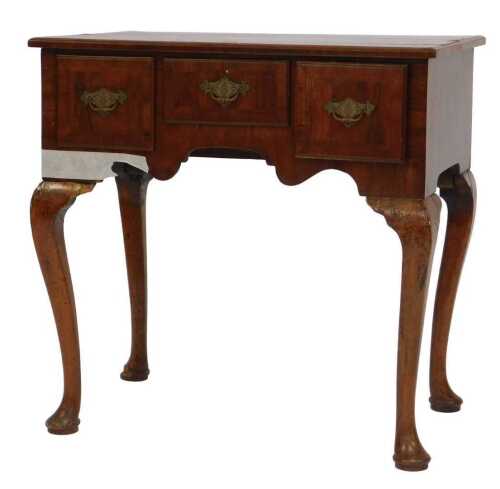 A mid 18thC and later walnut lowboy, the quarter veneered top with a cross banded border and a...