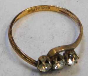 A three stone dress ring, set with three paste stones, on twisted design, on a rolled gold band,... - 2