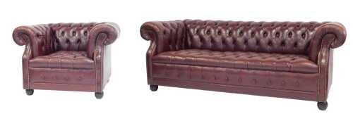 A burgundy red leather Chesterfield sofa, with brass studded borders, 195cm wide, and a matching...