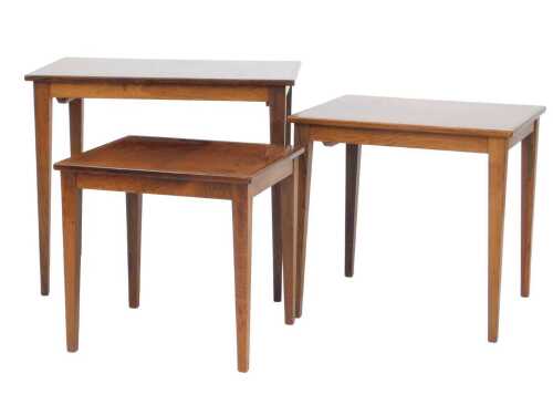 A nest of three 1950s/60s Danish rosewood tables, each with a rectangular top, on square...
