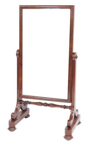 A Victorian mahogany cheval mirror, the rectangular plate on tapering supports, with bun feet,...