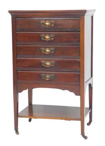 An Edwardian mahogany music cabinet, the top with a moulded edge, above five drawers with fall...