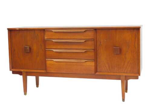 A Lebus teak sideboard, with four drawers, flanked by two doors, each with square handles, on...