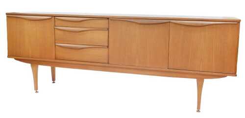 A 1960s/70s Stonehill Furniture teak sideboard, with three drawers and three doors, each with...