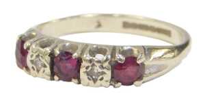 A 9ct white gold ruby and diamond half hoop dress ring, set with three round brilliant cut...