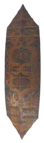 A Dayak Borneo Kliau wooden shield, of elongated hexagonal form, with black and red decorative...